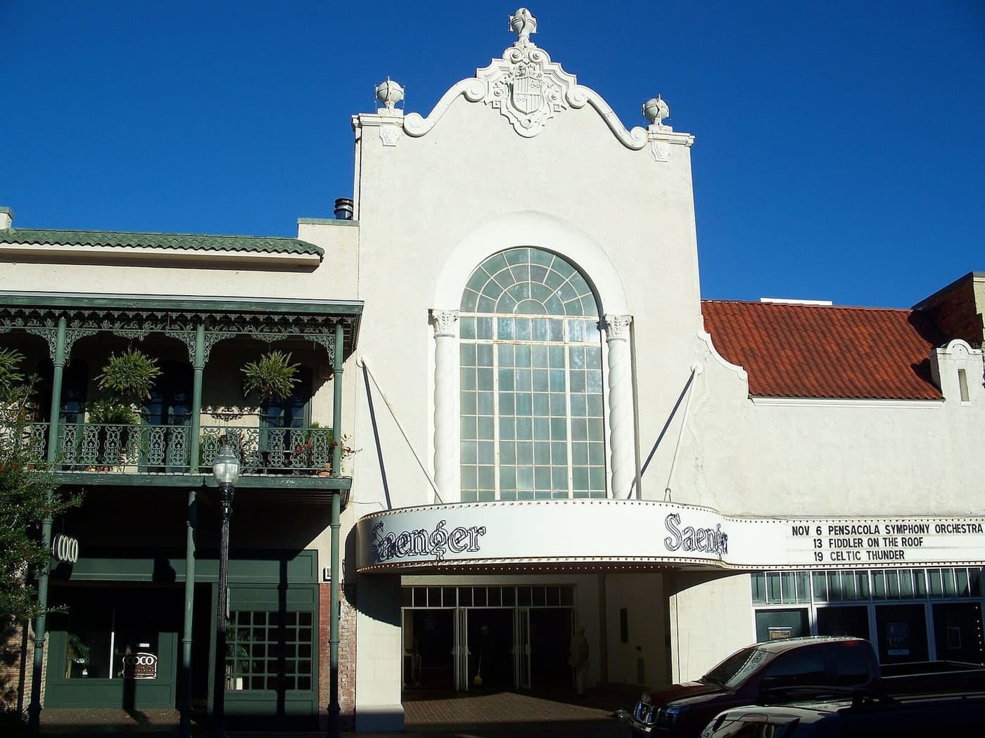 The Saenger Theatre marquee on Palafox Street in downtown Pensacola under a deep blue sky